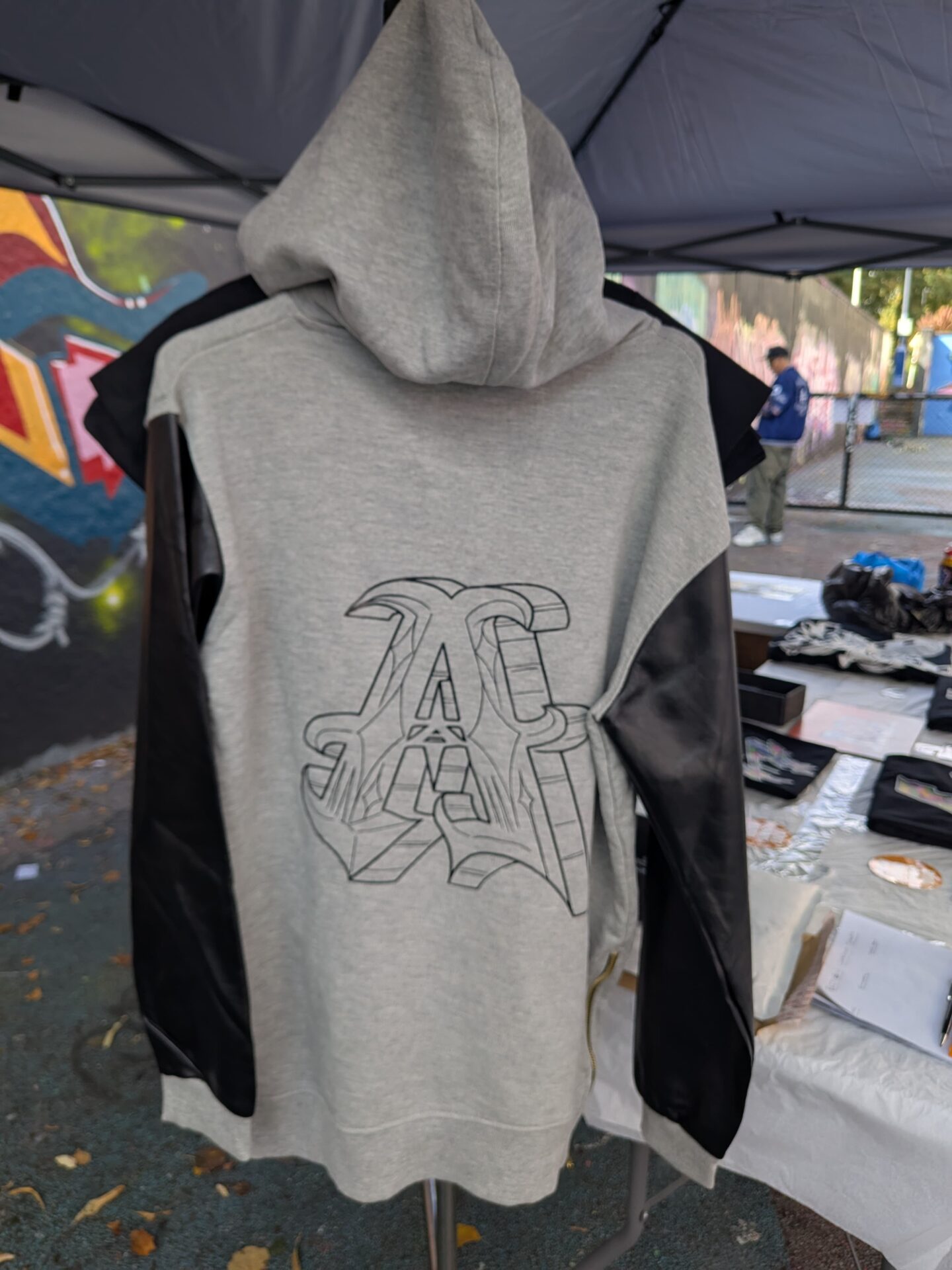 Grey original hoodie with faux leather sleeves.